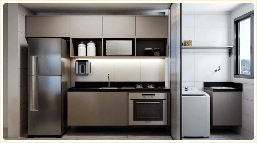 Cozinha moderna com armários cinza, eletrodomésticos prateados, bancada preta e área de serviço com tanque de lavar roupas.