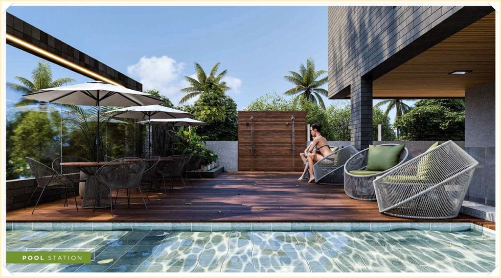 Área de lazer com piscina, espreguiçadeiras e mesas sob guarda-sóis, cercada por vegetação exuberante e um homem relaxando.
