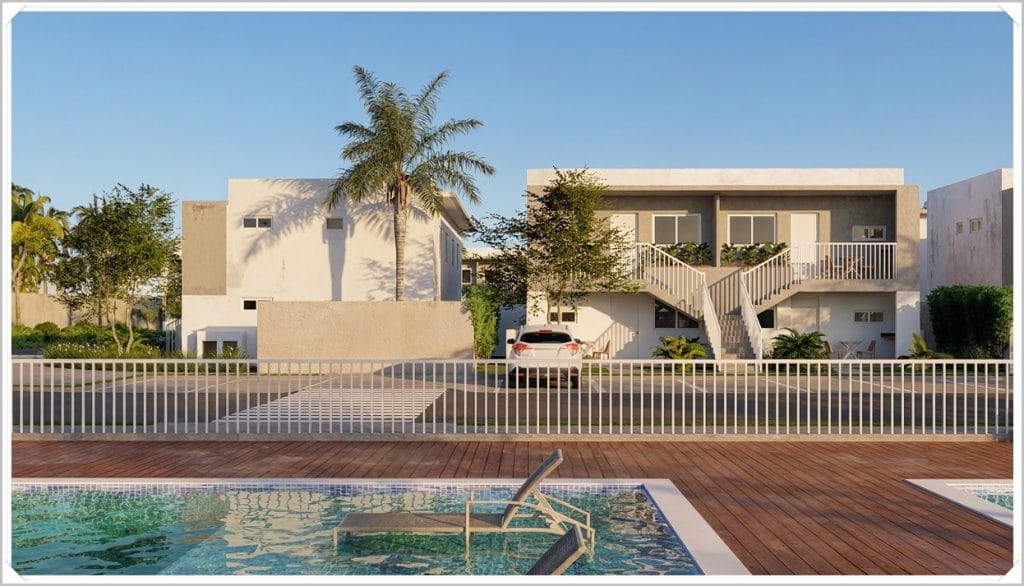 Condomínio de sobrado em Maceió, com piscina em primeiro plano, palmeiras e jardim na área externa, sob céu azul claro.