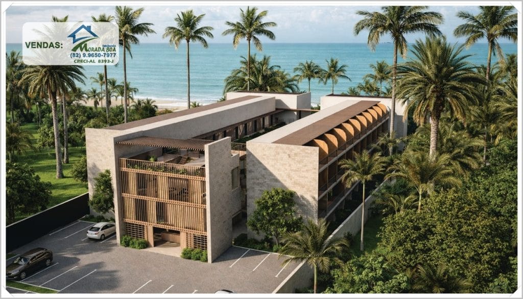 Prédio residencial com design moderno em meio a árvores e palmeiras, próximo ao mar azul de São Miguel dos Milagres. Vagas de estacionamento visíveis.